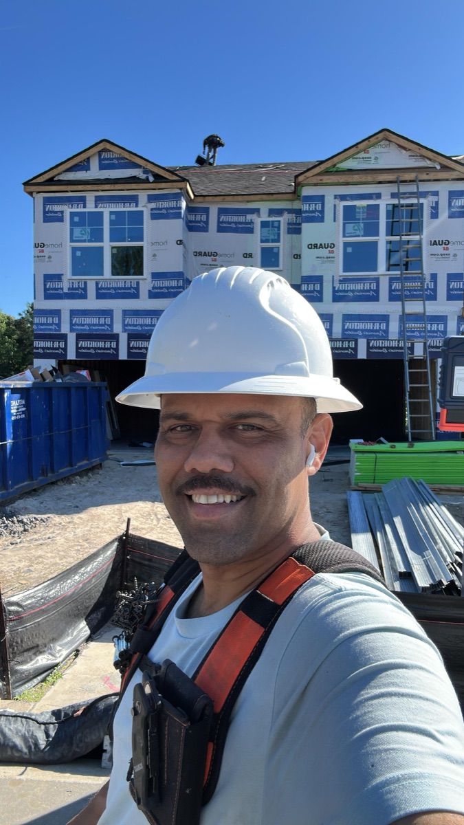 Professional installer of JC Encompass All wearing safety equipment on an active South Carolina residential construction site